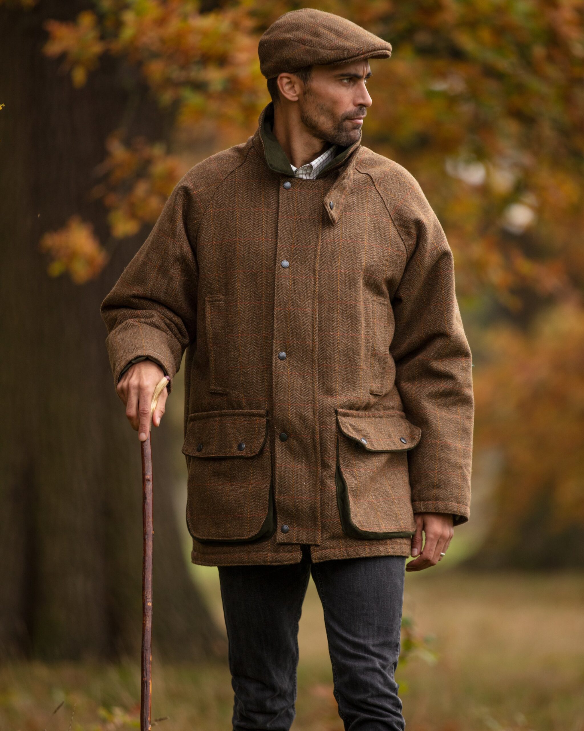 model wearing mens tweed jacket and flat cap in brown tweed
