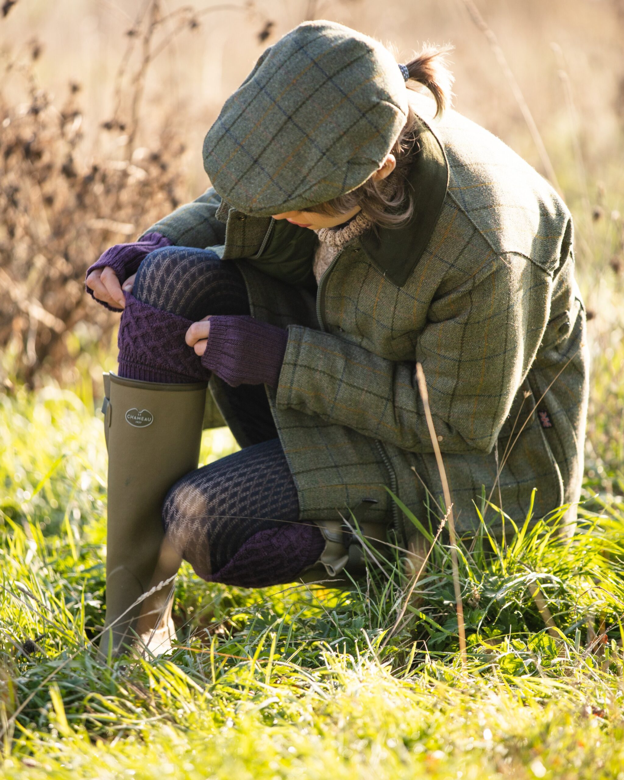 model wearing ladies tweed jacket and flat cap in navy stripe