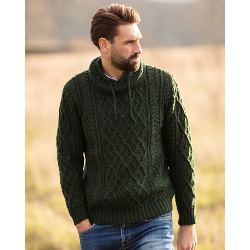 Male model wearing a Walker & Hawkes Blackburne jumper in dark forest.