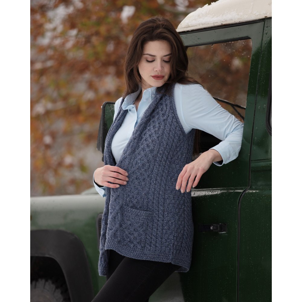 Female model wearing the Walker & Hawkes Elmore gilet in sky blue.