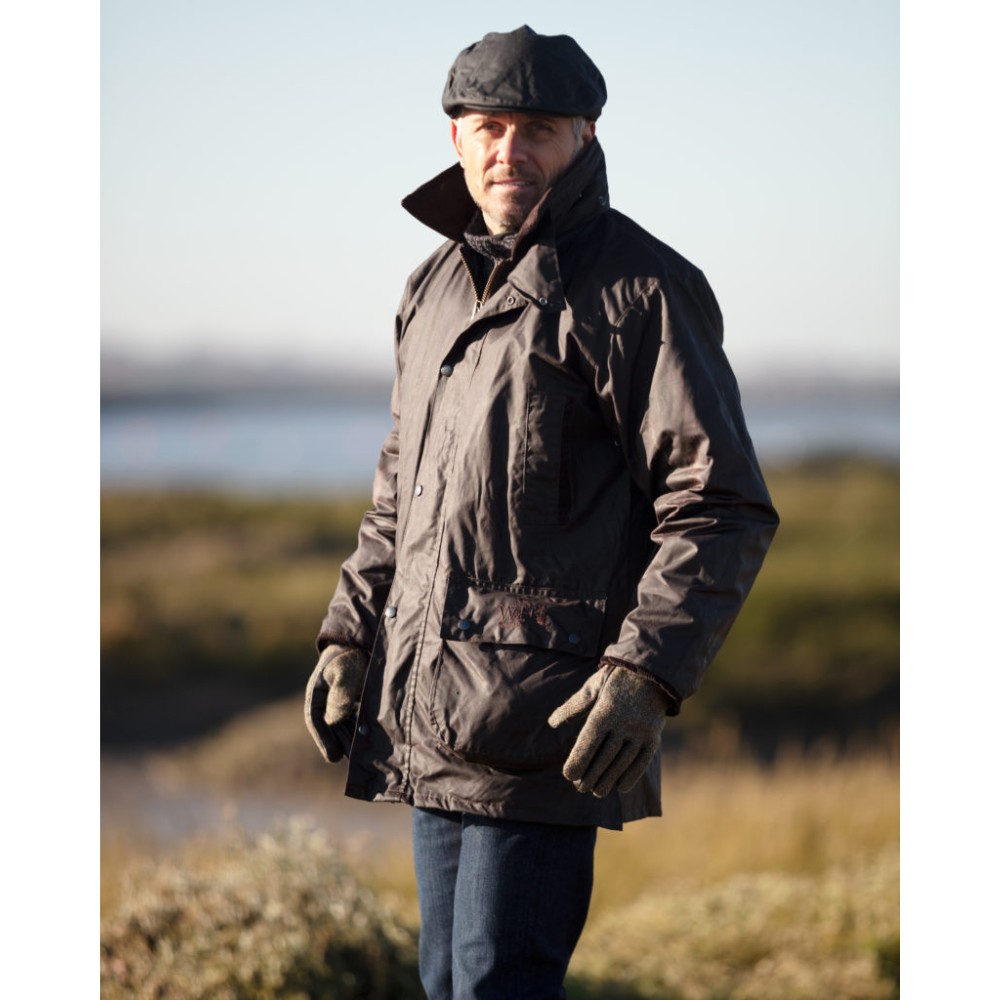 Male model wearing a Walker & Hawkes Greendale 3-in-1 jacket in brown.