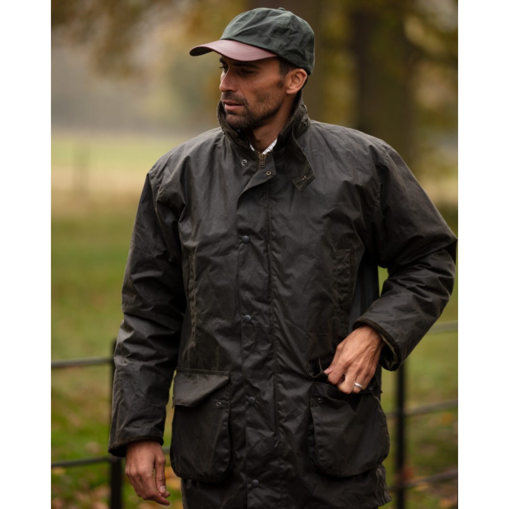 Male model wearing a Walker & Hawkes Greendale jacket in olive.