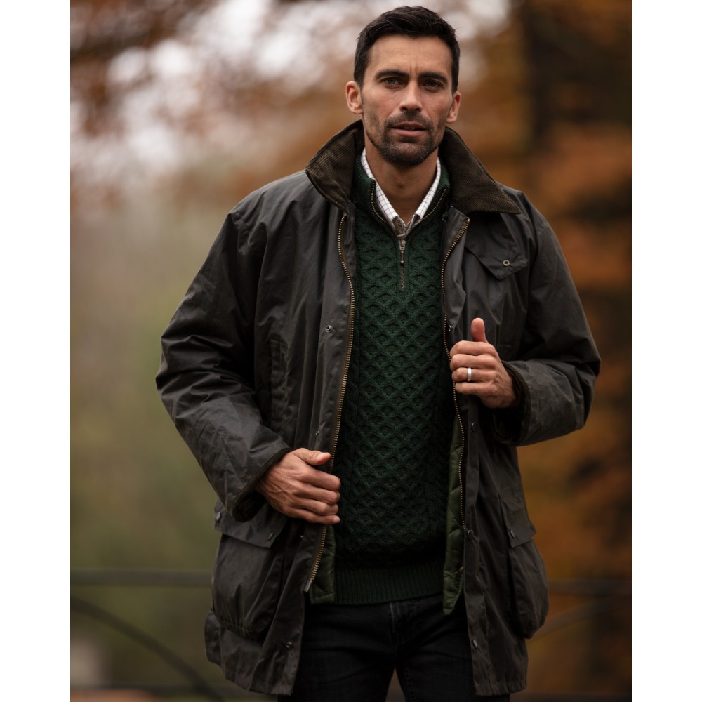 Male model wearing a Walker & Hawkes Greendale jacket in olive.