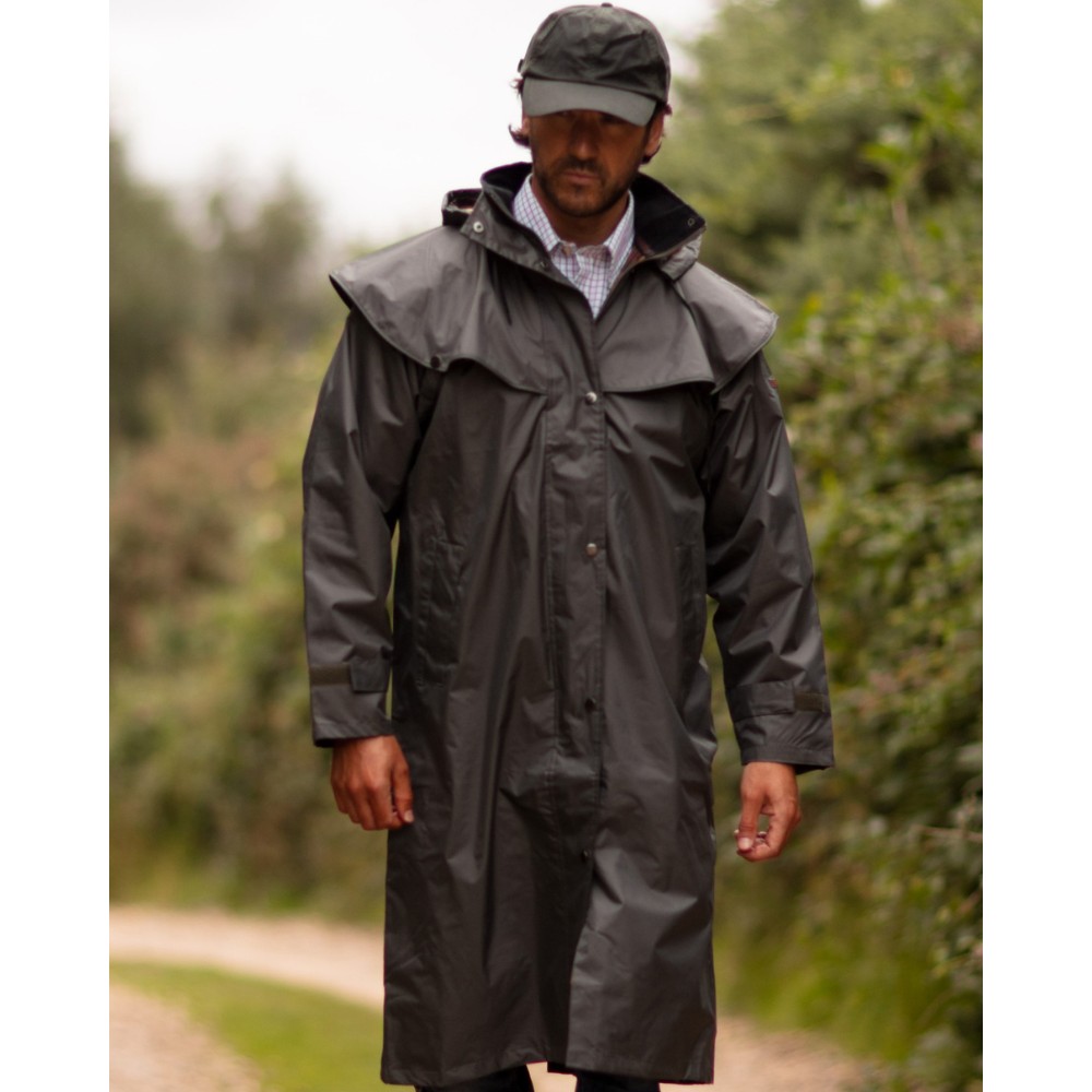 Male model wearing a Walker & Hawkes Midland cape coat in olive.