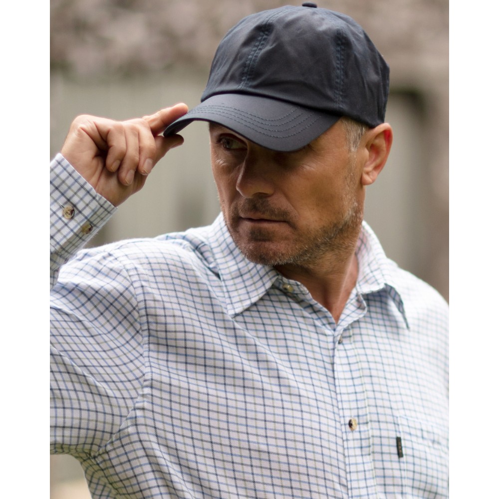 Male model wearing a Walker & Hawkes Bransford baseball cap in navy.