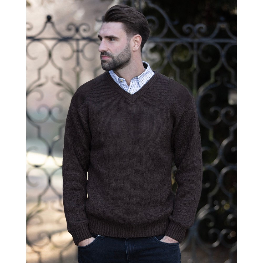 Male model wearing the Walker & Hawkes Men's Burdale V-neck jumper in brown.