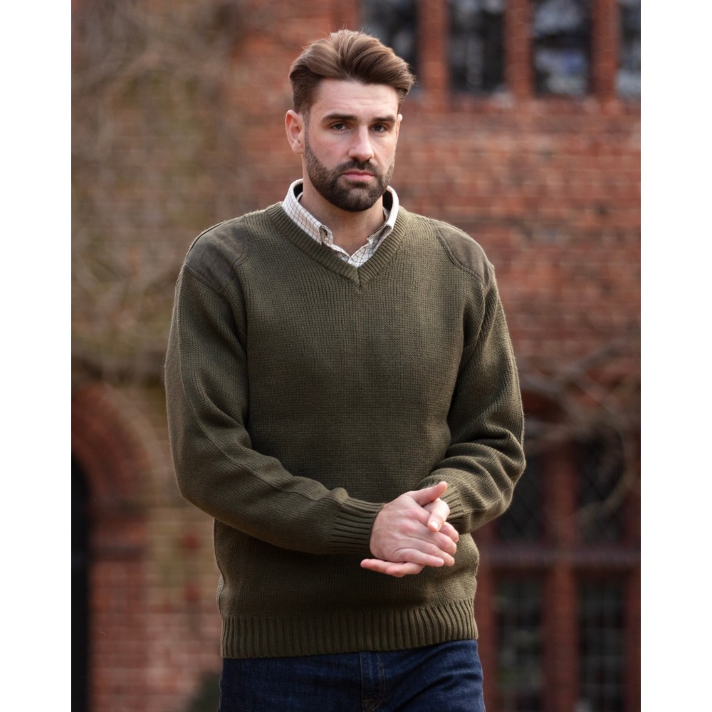 Male model wearing the Walker & Hawkes Men's Burdale V-neck jumper in green.