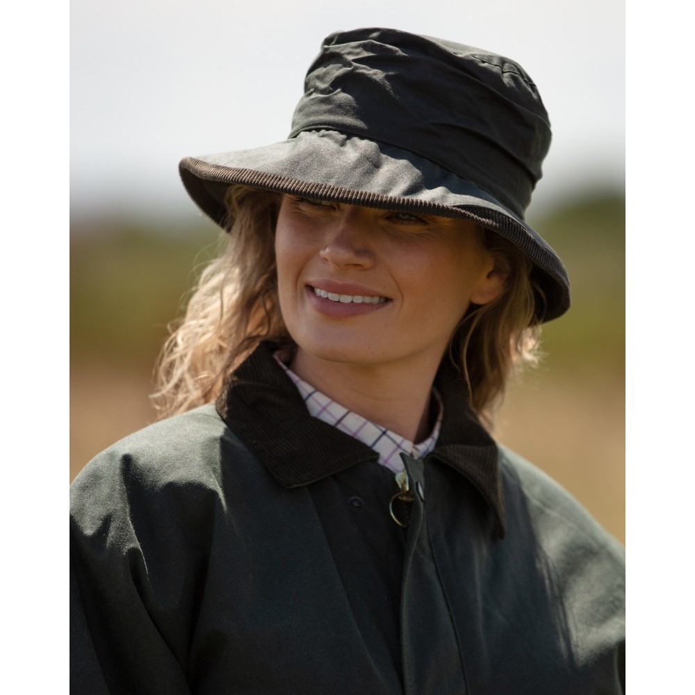 Female model wearing a Walker & Hawkes Diana hat in olive.