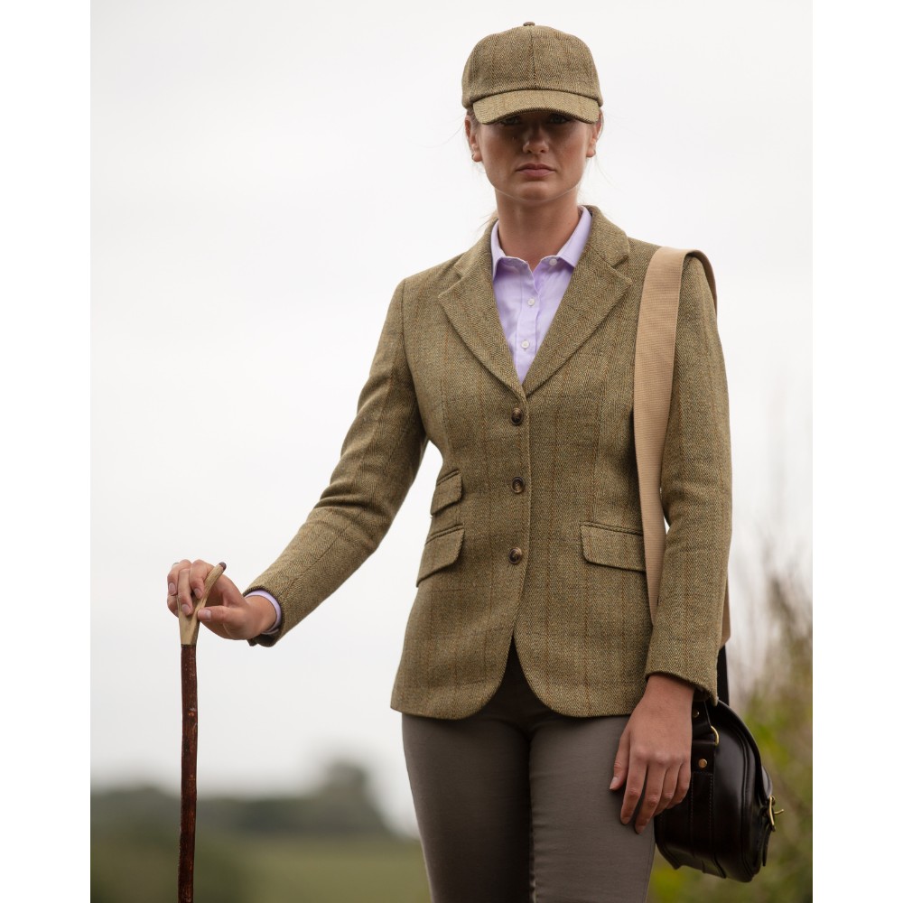 Female model wearing a Walker& Hawkes Ladies Derby Tweed Mayland Blazer in light sage.