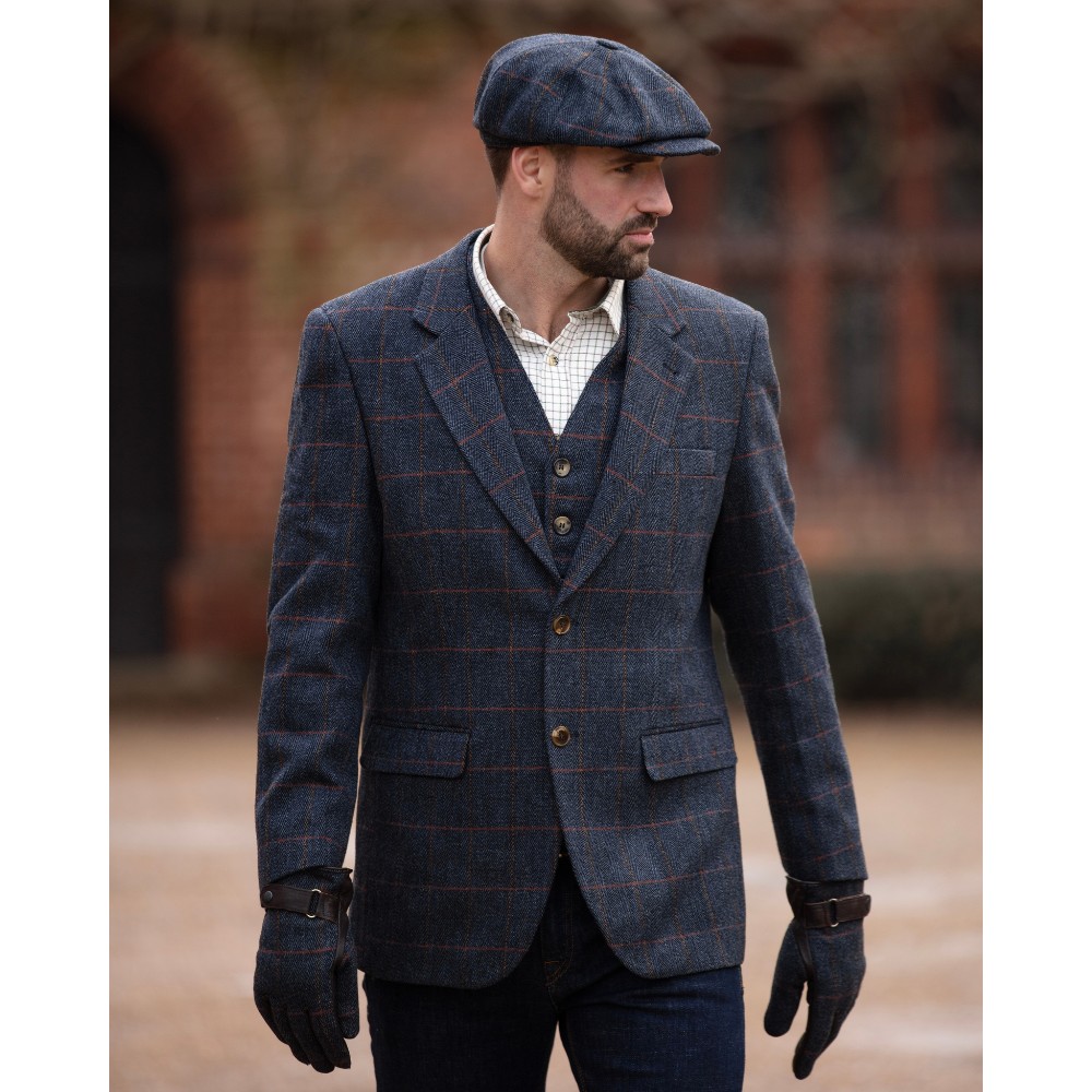 Male model wearing a blue Walker & Hawkes Men's Derby Tweed Windsor Blazer.