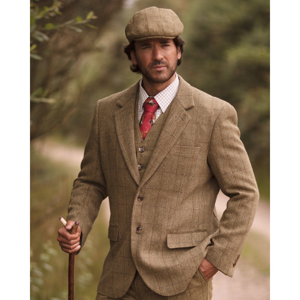 Male model wearing a light sage Walker & Hawkes Men's Derby Tweed Windsor Blazer while out for a walk.