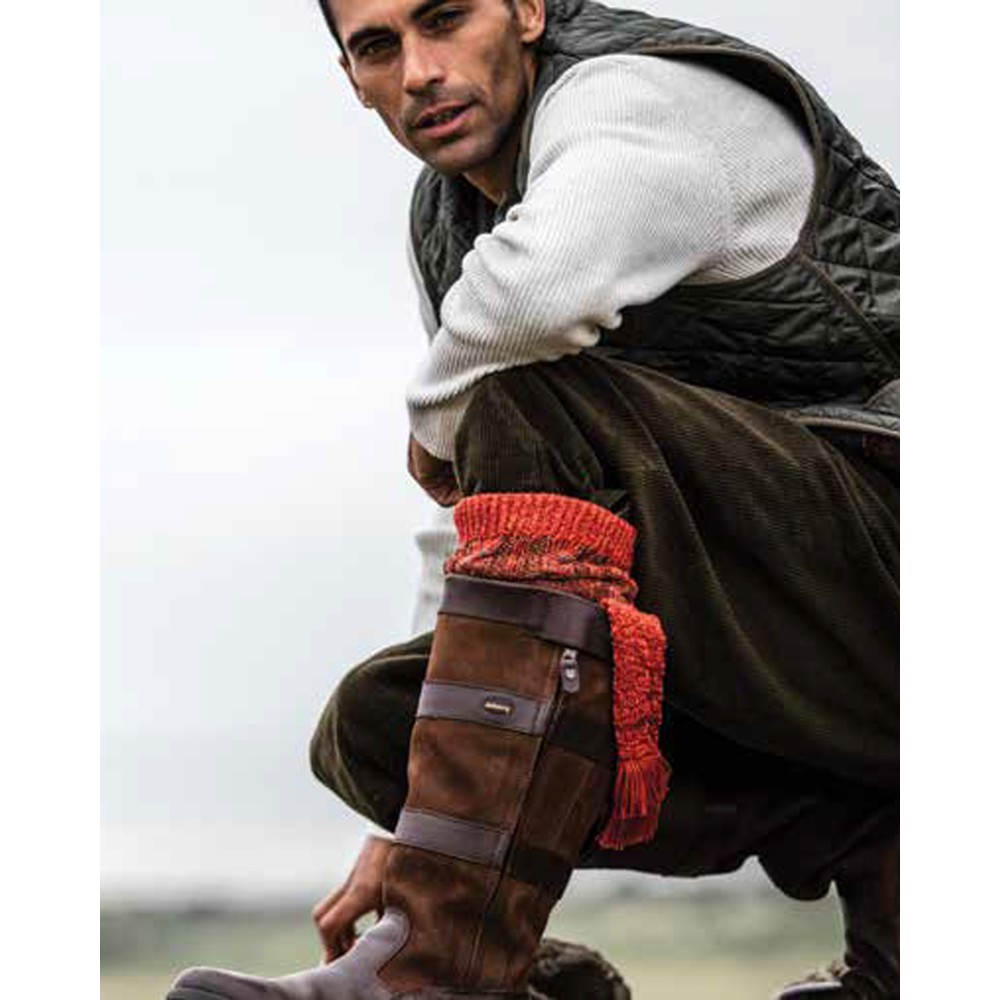 Male model out on the moors, wearing boots with Walker & Hawkes Revier socks in autumn glow.