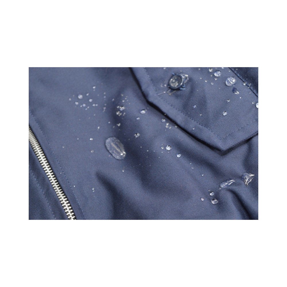 Navy blue jacket with beads of water on it having been treated with our Fast Dry Proof Waterproofer Spray for Outdoor and Technical Garments.