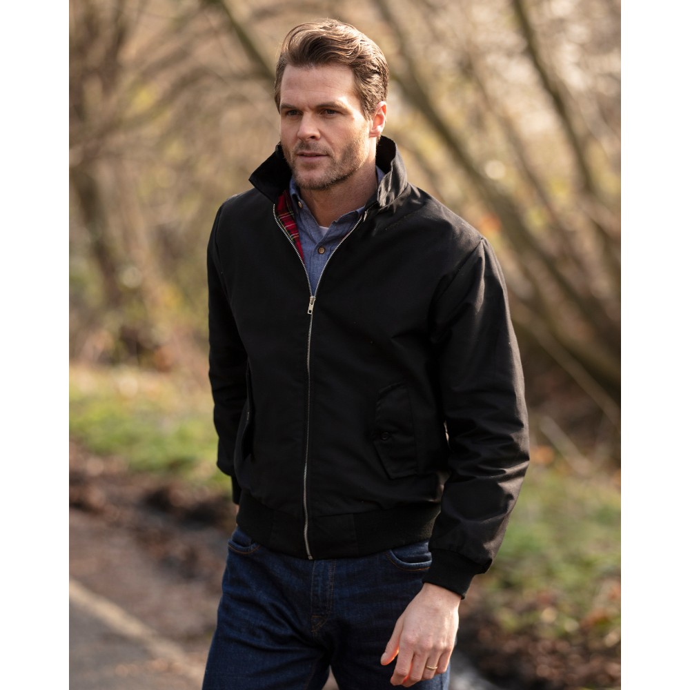 Male model wearing a Walker & Hawkes Harrington jacket in black.