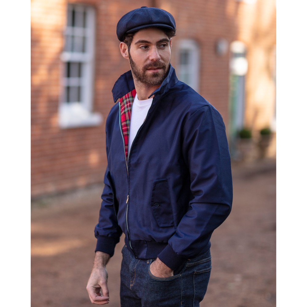 Male model wearing a Walker & Hawkes Harrington jacket in blue.