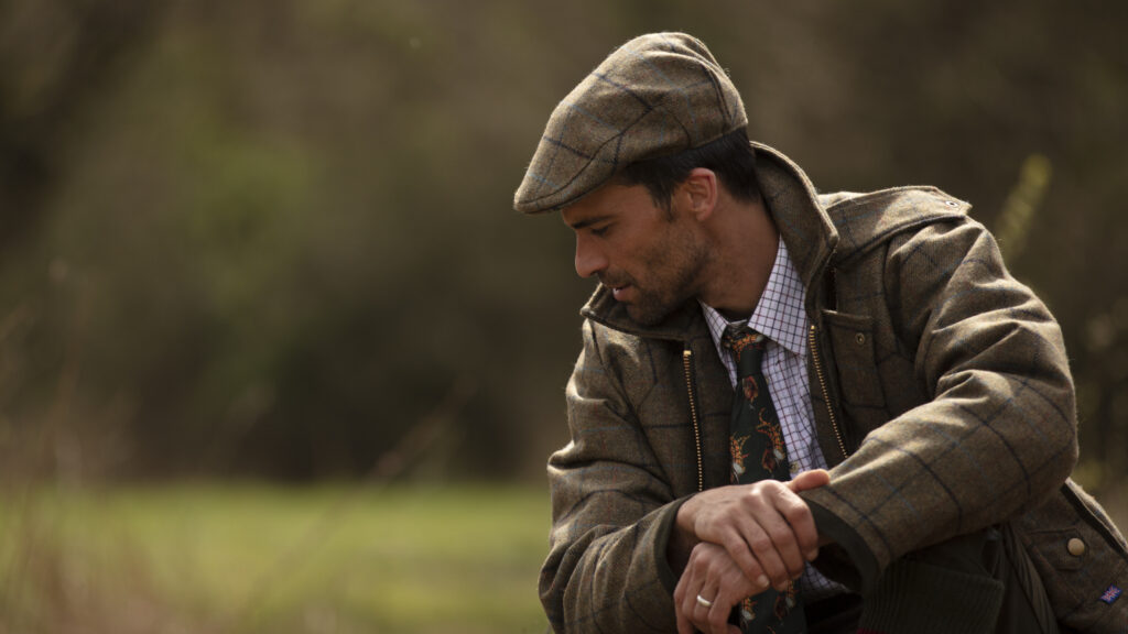 Man in Walker & Hawkes hat and jacket.