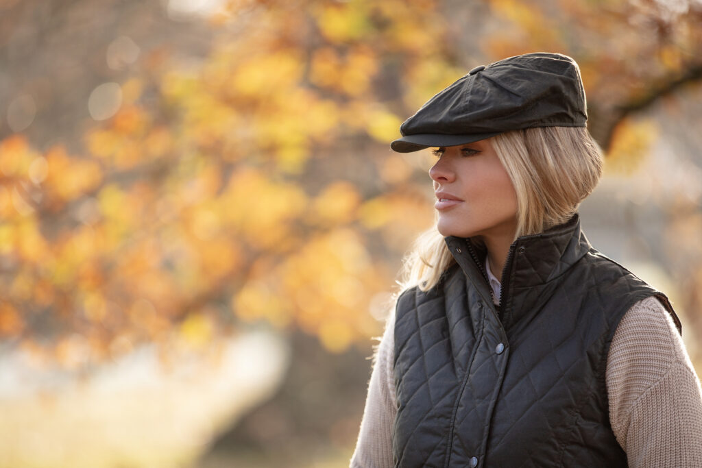 Woman wearing a wax jacket and a gilet on an autumn day.