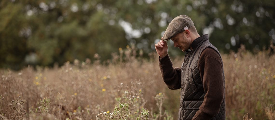 Man wearing a tweed flat cap.